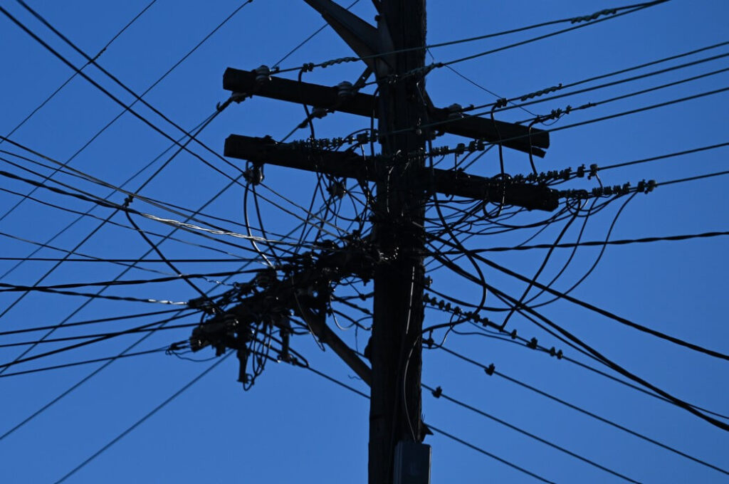 Get ready for steep price hikes: power bills to soar by more than 20 per cent in NSW Electricity poles and wires in Sydney